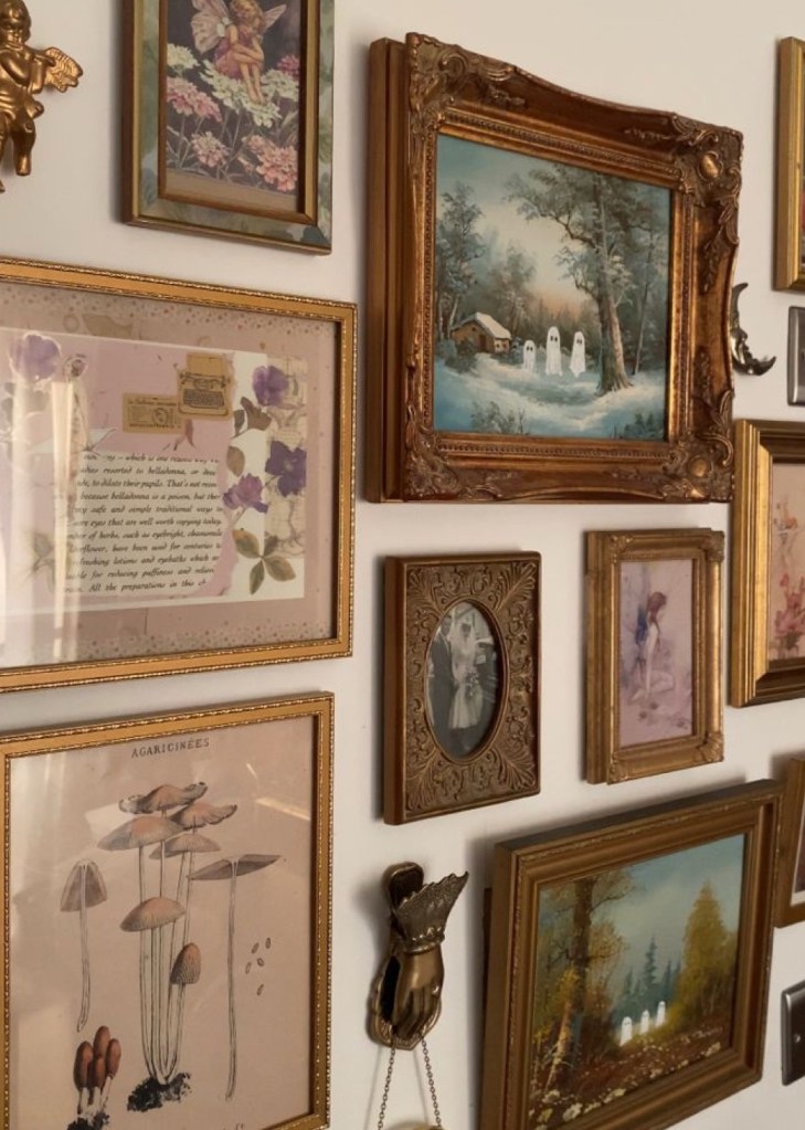 a gallery wall with antique vintage gold frames floral prints oil paintings in traditional decor style cottagecore