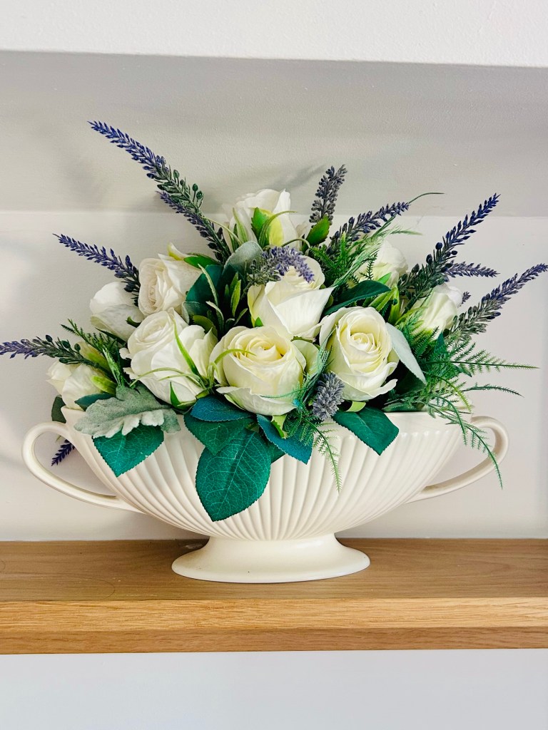 faux rose and lavender arrangement in vintage wedgewood mantle vase